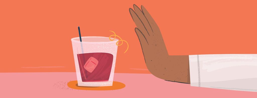 A hand pushing away a cocktail