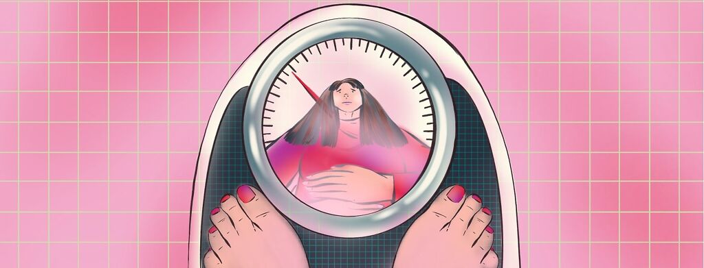 A woman's reflection is shown in the glass over a dial on a scale