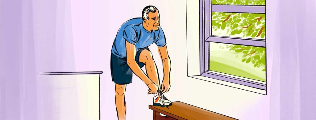 A man ties his shoe in preparation for a run